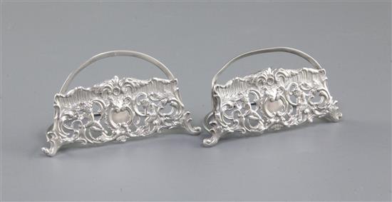 A pair of silver semi circular menu holders, by William Comyns, LENGTH; 3”/79mm Height; 1 ¾”/44mm